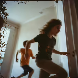 two people are running through an open door