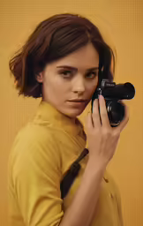 the woman is posing with a camera