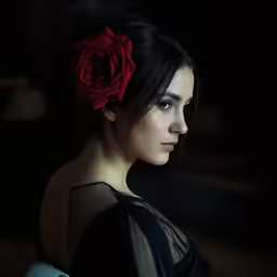 a woman with a red rose in her hair