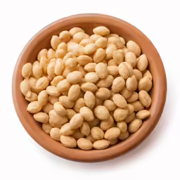 a wooden bowl full of peanuts