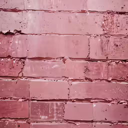 old red brick wall with little cracks and paint peeling off