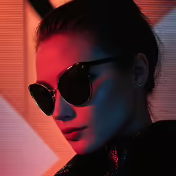a woman wearing sunglasses looking at the camera