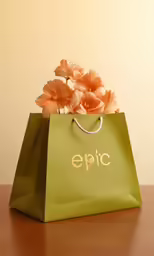 green shopping bag sitting on wooden table with orange flowers