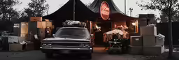 the truck is parked outside of the storage shack