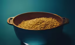 a blue bowl full of cereal on a table