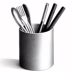 silverware and spoons in a white cup on a table
