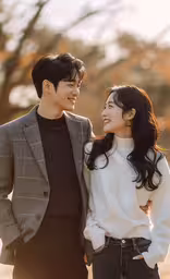 two people standing together and looking at each other,the young couple is standing together looking at each other