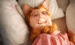 a cat like doll is making an expression while sleeping