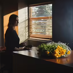 a woman preparing food in a kitchen, with sunny light coming through the window