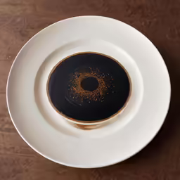 a cup of coffee and saucer on a plate