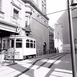 trolley car on tracks through small city