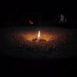 candle burning in open area at nighttime time