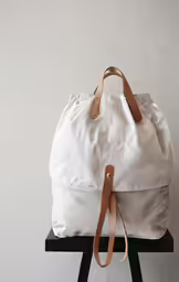 the large backpack is sitting on top of a chair