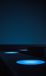 a large circular light in a black room