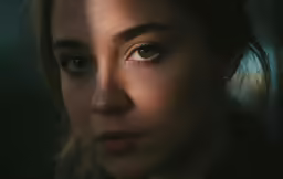 a woman looking into the camera while wearing eye makeup