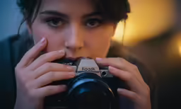 a young woman taking a picture of herself with her camera