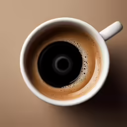a cup filled with liquid next to a brown wall