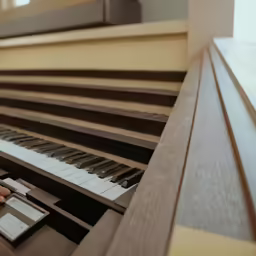 the keys are in front of a large piano