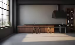 a kitchen with three stools in front of the counter