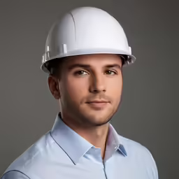 a man wearing a white hard hat