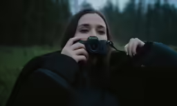 a woman is taking a photo with her camera