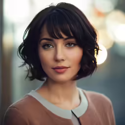 a lady with medium hair is smiling at the camera