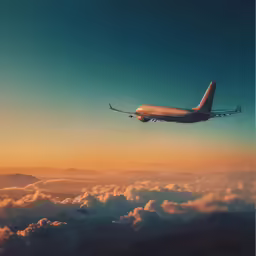 an airplane flying over the clouds in a sky