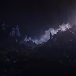 the man is standing in the dark next to mountains