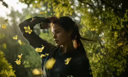 a woman with her hair pulled back in a ponytail, surrounded by lots of butterflies