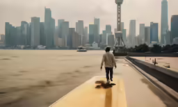 person walking across yellow ledge over water with city background