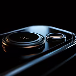 two black electronics sitting in the middle of a dark place