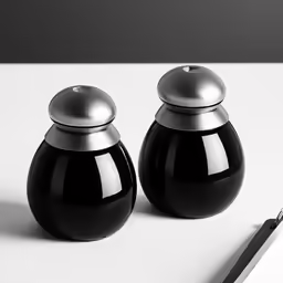 two black jars sit next to an empty notepad