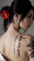 a woman with tattoos showing the back of her body