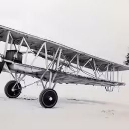 a vintage airplane on a snowy day in the winter