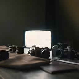 a closeup view of some old cameras and a small television