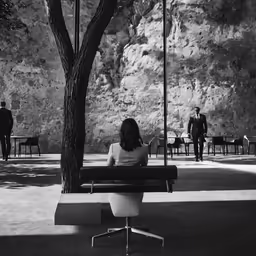 the woman is sitting alone alone on the bench