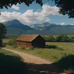 a rustic old barn in the mountains, near a dirt road