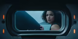 woman looking at herself while sitting in the mirror