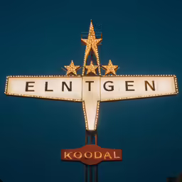 an old style christmas sign has star lights on it