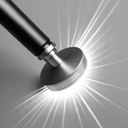 a shiny umbrella is pictured lit up by lights coming from the top