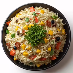 this is a colorful pasta salad in a black bowl