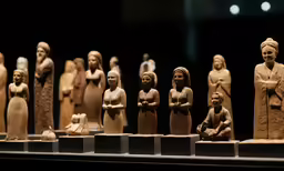 statues of women with a small child, in front of them