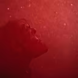 the image shows the person with the red background