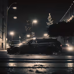 cars driving through an intersection in the rain at night