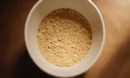 an aerial shot of a white bowl with brown stuff inside