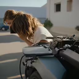 a person leans over while putting their head on the bike