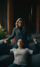 two women sitting on the floor in a dark room