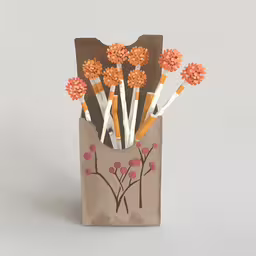 a brown bag holds many sticks and flowers,a bag filled with flowers and decorative pens