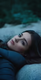 a woman is lying down on the cement