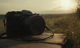 a digital camera that is sitting on the edge of a bench